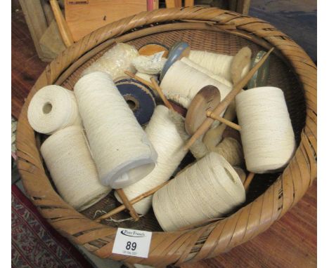 Large woven basket containing various bobbins and yarn on spools, together with a variety of wool carding brushes marked 'Mar