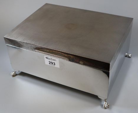 An early 20th Century silver cigarette box of large proportions by William Neale & Son, Birmingham 1928, standing on ball and