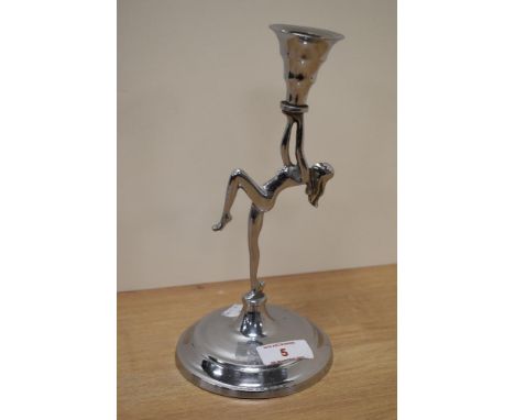 An Art Deco style chromium plated candlestick, depicting nude lady.