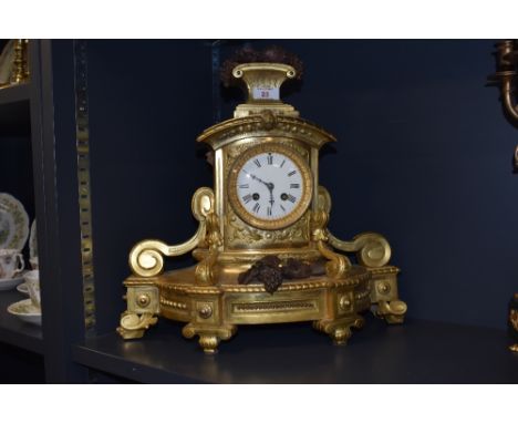 A 19th century ormolu clock, having grape decoration to foot and finial and enamel face with Roman numerals, key included, J 