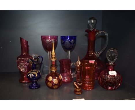 A collection of coloured glass, including Perfume bottles, blue jug with enamel decoration, decanter and two cut glass wine g