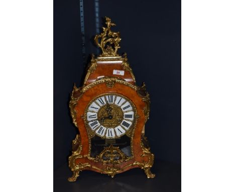 A late 20th century Italian mantel clock, having burr walnut effect case with brass foliate accents, with Roman numerals to e