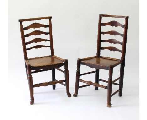 A near pair of ladder back chairs with solid seats, on turned legs