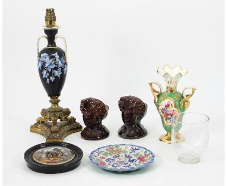A pair of glazed figural window chocks, a porcelain gilt metal mounted lamp, a framed pot lid etc.