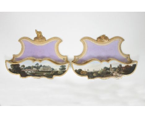A pair of Chamberlains Worcester wall pockets, each with bird nest finial to a shaped puce back, one painted with a named vie