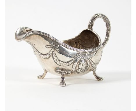 A Continental silver sauce boat, import marks London 1899, with portrait medallions to the sides hung with swags, approximate