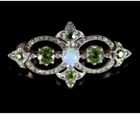 An Edwardian opal, peridot and diamond brooch, the central opal to an openwork border set with peridot and diamonds, 4cm wide