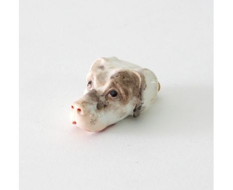 A 19th Century porcelain dog's head whistle, 4.5cm long Condition Report: The enamel and gilding are badly rubbed and there i