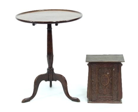 A mahogany circular table on a turned column and tripod support, 55cm diameter and a small carved oak hanging cupboard, 31cm 