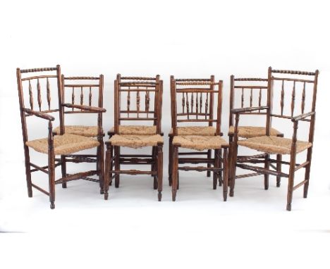 A set of eight spindle back rush seat dining chairs with bobbin turned top rails on turned legs and stretchers, comprising si