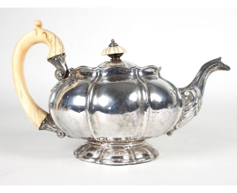 A George IV melon-shaped silver teapot, William Eaton, London 1825, the cover with ivory finial and fitted a carved ivory han