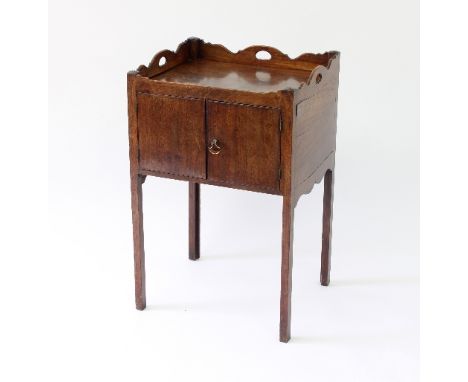 A George III mahogany tray top commode, enclosed by a pair of panel doors on square legs, 51cm wide Condition Report: Top sta