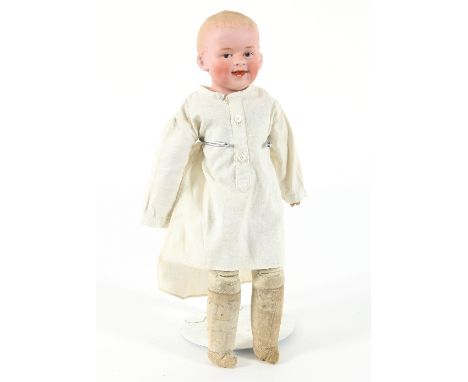 An early 20th Century German bisque head boy doll, marked '3' to head, open mouth with two teeth, intaglio eyes, moulded hair