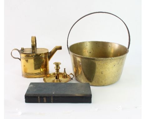 A large brass preserving pan with crossover handle, a Jersey hot water can, a brass chamber stick and a ledger