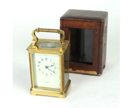 A brass carriage clock with cream enamel dial and Arabic numerals, with presentation inscription, 15cm high Condition Report: