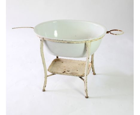 A baby's oval white enamel bath with wrought iron stand, 77cm wide