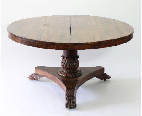 A Regency rosewood circular dining table raised on a turned and carved column and flat tripod base, with hair claw feet, 134c