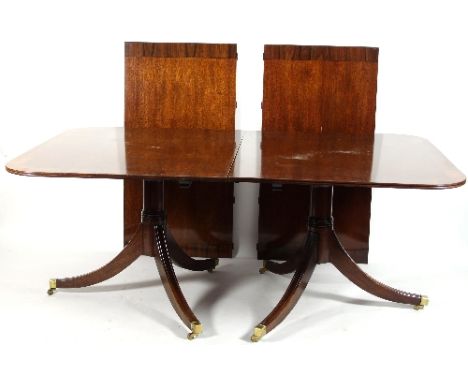 A reproduction twin-pedestal dining table, in solid mahogany with crossbanding of rosewood, D-shaped ends, extending to 304cm