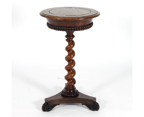 A William IV rosewood jardinière table, the circular top with lift out lid, gadrooned border and twisted stem column on a tri