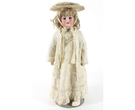 A Simon & Halbig bisque head doll, stamped '1079 DEP, 11½ inch', open mouth and sleeping eyes, in a silk dress with lace jack