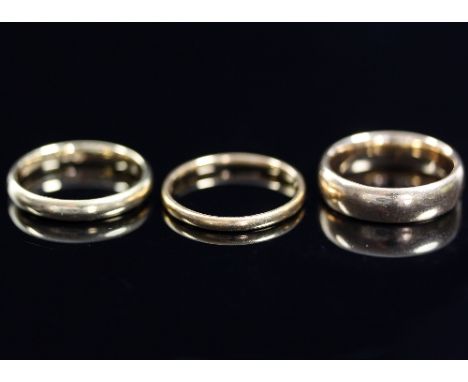 An 18ct gold wedding band, size K and two other gold wedding bands, approximately 10gm