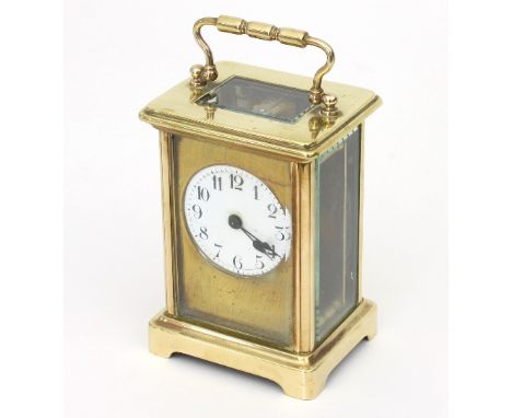A gilt brass cased carriage clock, the white enamel dial with Arabic numerals, 14cm high handle up
 Condition Report: Solid b