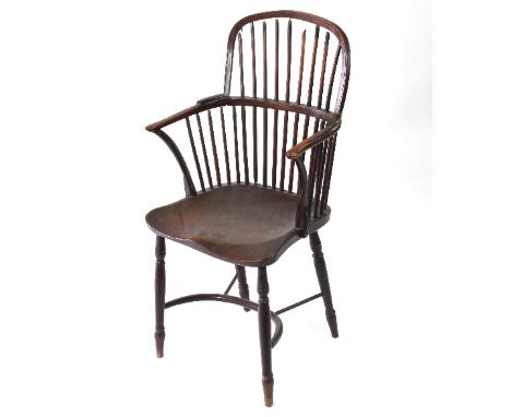 A Windsor type stick back armchair, with dished elm seat, turned legs and crinoline stretcher Condition Report: Damaged