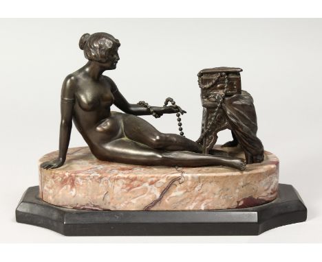 A BRONZE DECO NUDE on a marble base. 10ins long.