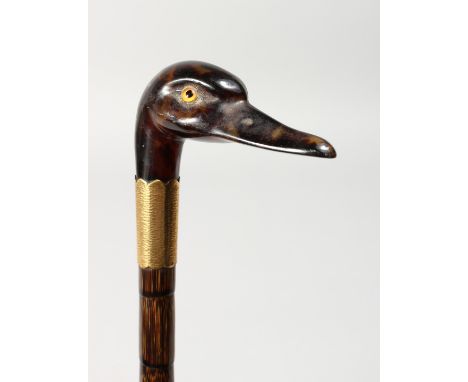 A VICTORIAN CARVED DUCK'S HEAD WALKING STICK, maker J. H. with two gilt bands, originally an umbrella. 34ins long.