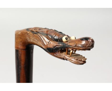 A CHINESE CARVED DRAGON HANDLE WALKING STICK. 34ins long.