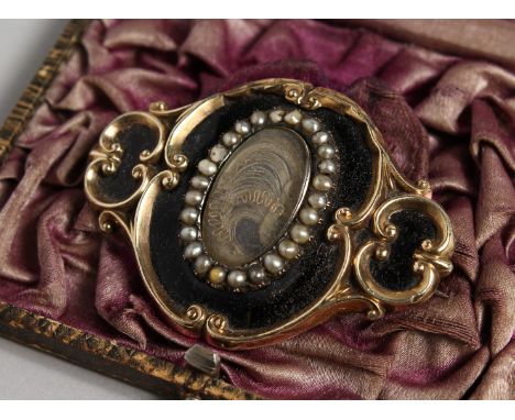 A MOURNING BROOCH, inscribed 14th September 1852, Augustus W. Pugin, the front with black enamel, seed pearls around plaited 