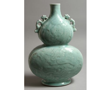 A CHINESE LIGHT BLUE DOUBLE GOURD VASE. Monogrammed in blue. 13ins high.