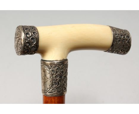 A VICTORIAN IVORY AND SILVER HANDLED WALKING STICK. London 1904. 34ins long.