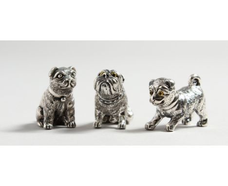 THREE CAST SILVER DOGS.