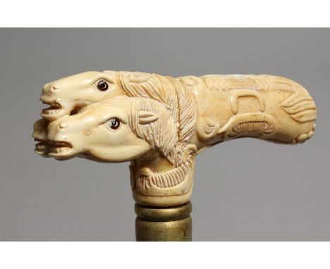 A WALKING STICK with bone handle, THREE HORSE'S HEADS.