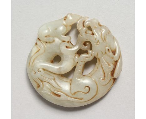 A CARVED JADE DRAGON ROUNDEL. 2ins.