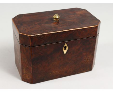 A GEORGE III AMBOYNA TEA CADDY, the hinged lid enclosing two compartments. 7ins wide.