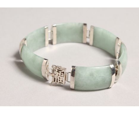 A CHINESE SILVER AND JADE BRACELET.