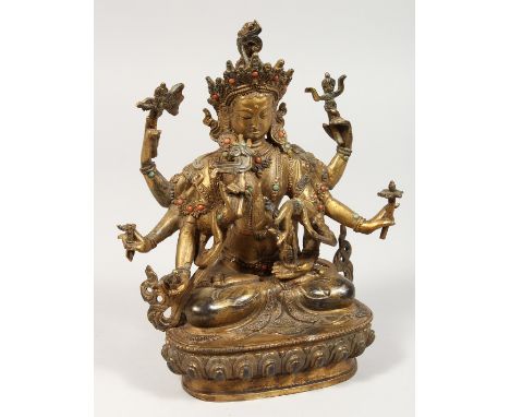 A CHINESE GILT BRONZE DEITY with eight arms. 8.5ins high.
