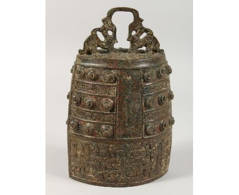 AN ARCHAIC BRONZE BELL. 11ins high.