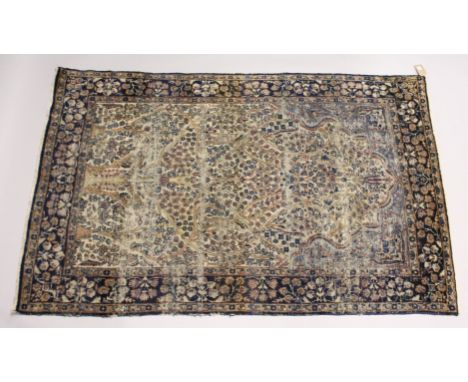 A PERSIAN KERMAN CARPET, cream ground with stylised tree design. 7ft x 4ft 5ins.