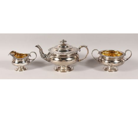 A GEORGE IV SCOTTISH SILVER THREE PIECE TEA SET, with cast shell and scroll sides, teapot, sugar basin and milk jug. Edinburg