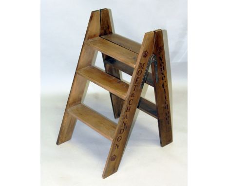 A WOODEN CHAMPAGNE FOLDING LADDER 2ft 8ins.