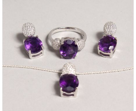 A SILVER AMETHYST SET RING and EARRINGS.