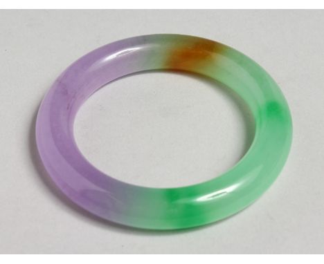 A MULTI-COLOUR JADE BANGLE.