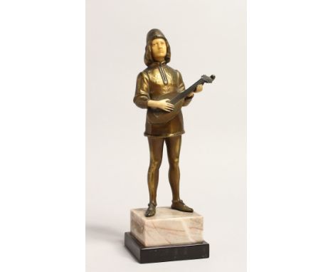 AN ART DECO GILT BRONZE AND BONE YOUNG MAN playing a mandolin, on an onyx base. 10.5ins high.
