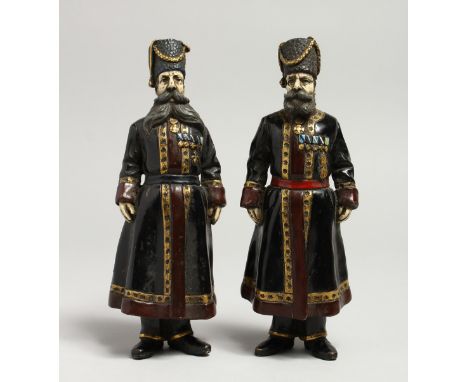 A GOOD PAIR OF RUSSIAN BRONZE FIGURES OF BEARDED MEN. 7ins