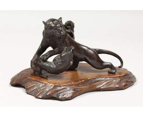 JAPANESE BRONZE TIGERS on a wooden base. 8ins long.
