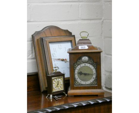 A small reproduction bracket style clock, miniature clock and a quartz wall clock 