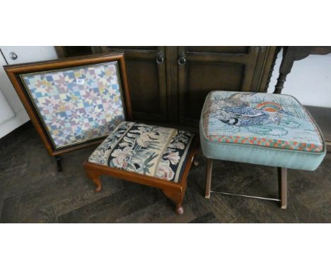 Two needlework top footstools and a needlework panel fire screen 